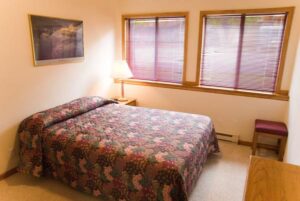 XL Condo A16 - Bedroom With Queen Bed And Nightstand | Alpenglow Vacation Rentals Ouray