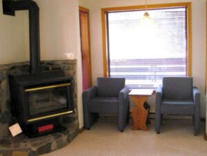 XL Condo A17 - Sitting Area Next To A Stove | Alpenglow Vacation Rentals Ouray