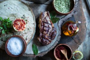 A steak with spices and dip served on a log | Alpenglow Vacation Rentals Ouray