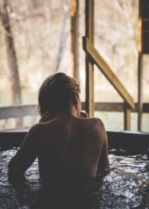 A woman taking a bath in a spa tub | Alpenglow Vacation Rentals Ouray