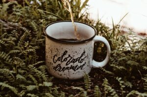 Pouring a tea into Colorado Dreamin' Mugg | Alpenglow Vacation Rentals Ouray